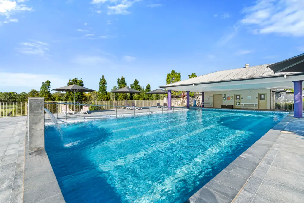 Outdoor swimming pool with umbrellas and lounge chairs