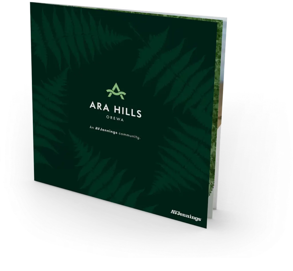 A square brochure with a dark green cover, featuring fern leaf patterns, the text "ARA HILLS OREWA,"