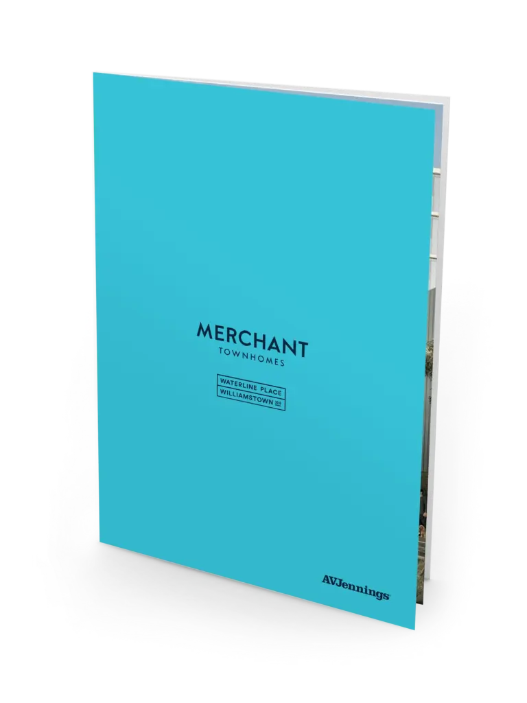 A bright blue booklet standing upright with the title "Merchant Townhomes" and the text "Waterview Place, Williamstown" on the cover, along with the AVJennings logo at the bottom.
