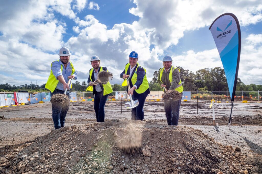 Four workers break ground at construction site