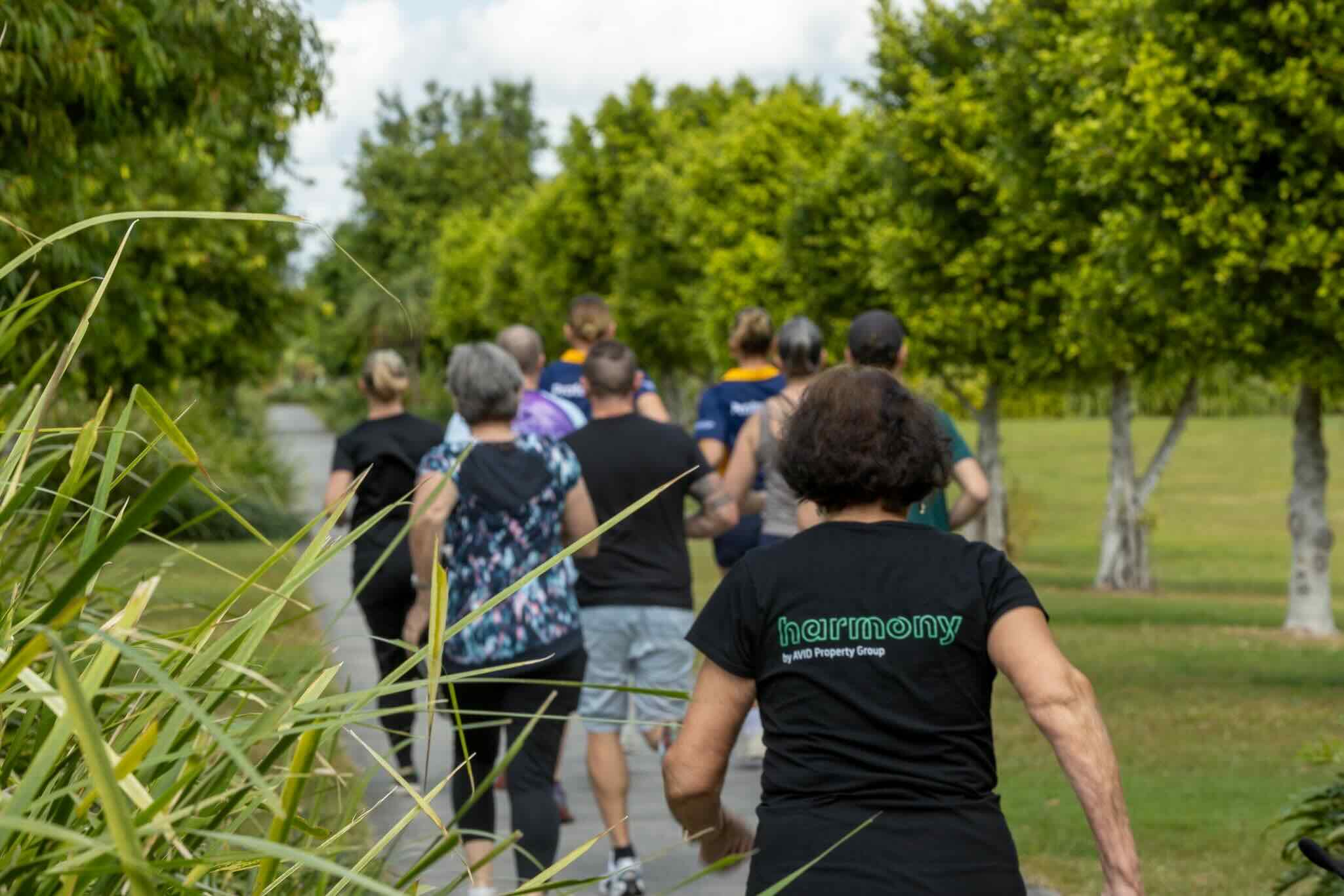 Group jogging along leafy park pathway