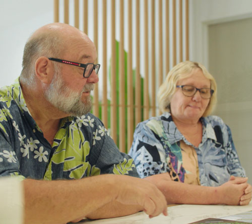 Older couple reviewing documents at table indoors
