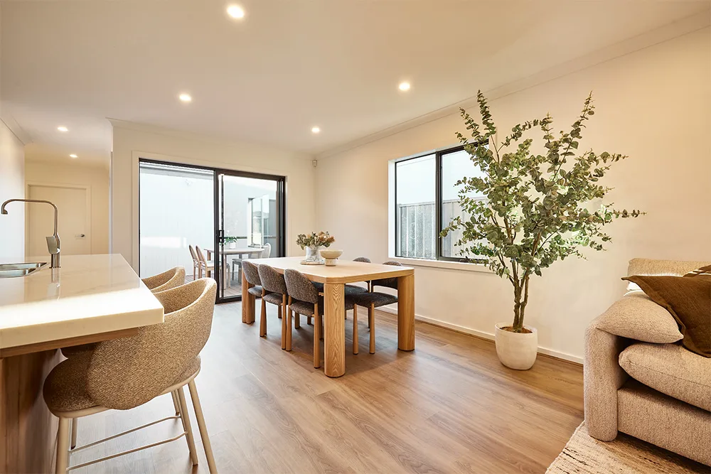 Modern dining area with wooden table and indoor plant