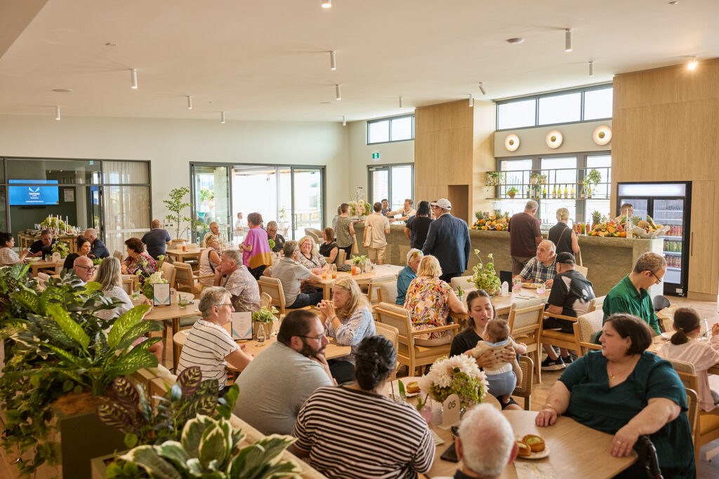 Guests dining in a bright, busy modern restaurant
