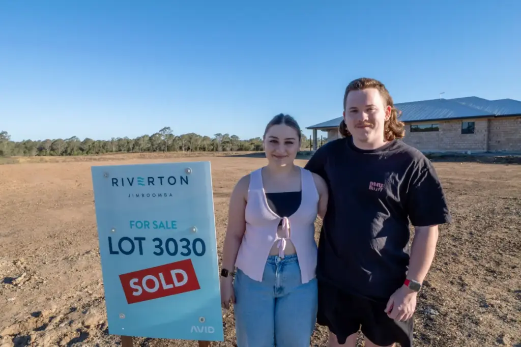 Couple beside sold Riverton Jimboomba lot sign